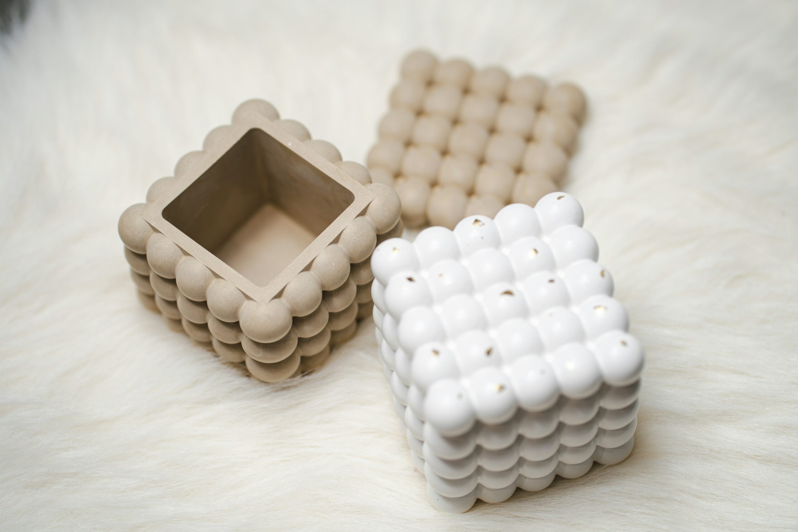 A white and a brown object sitting on top of a fur covered floor